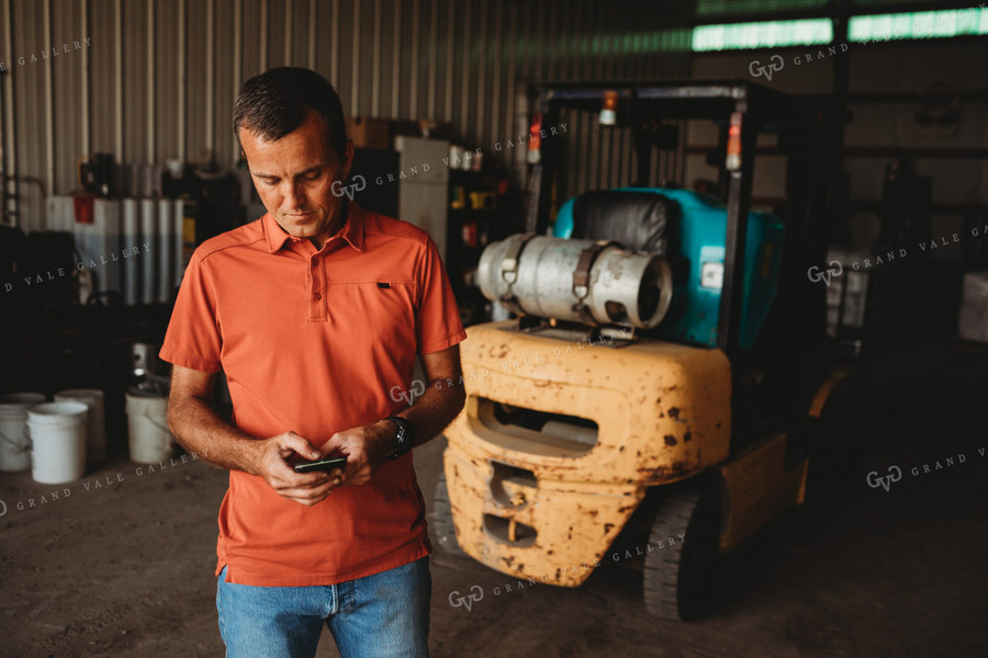 Farmer on Phone in Shop 4521