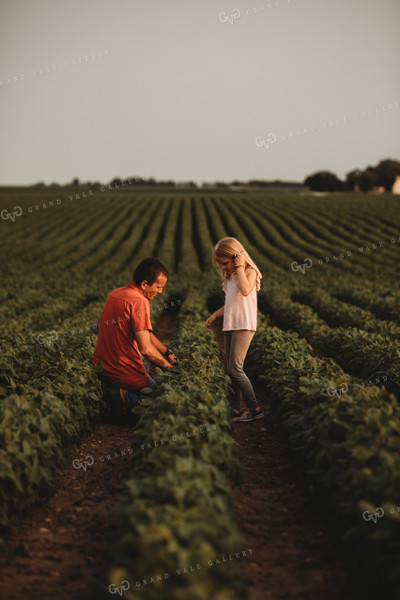 Farmer and Farm Kid Checking Crops in Soybean Field 4580