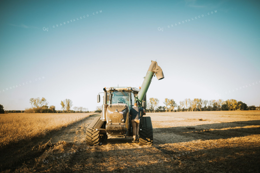 Farmer Climbing into Auger Wagon 5073