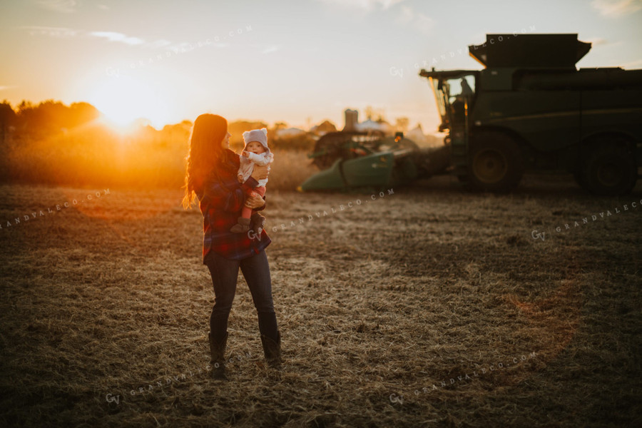Farm Mom and Wife with Baby in Soybean Field with Combine 5106
