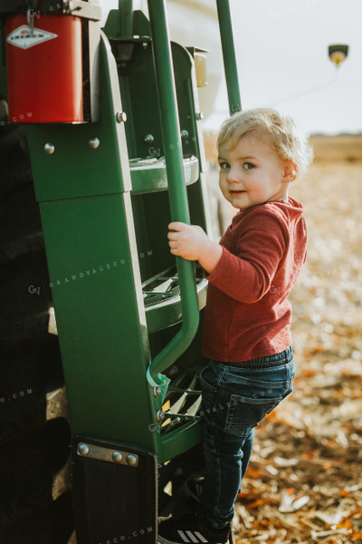 Farm Kid Climbing Tractor in Field 5245