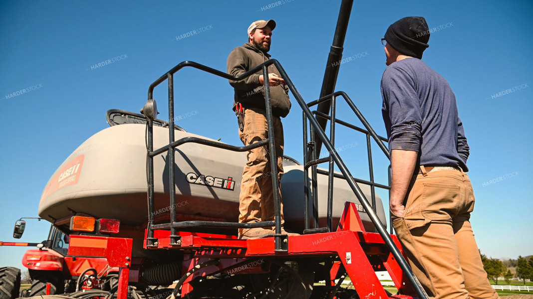 Farmer Loading the Planter with the Seed Tender 25099