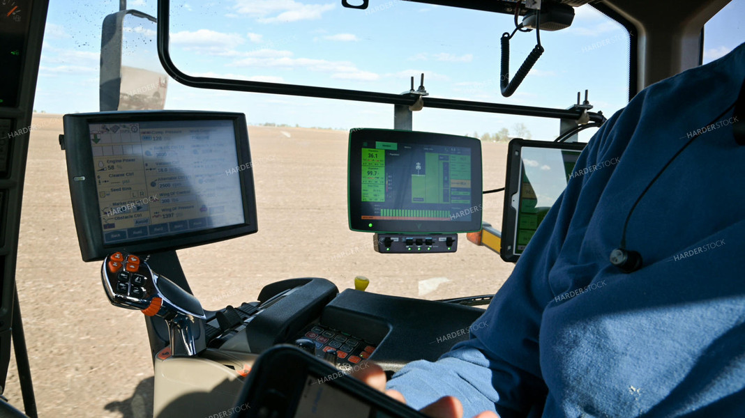 Farmer in the Tractor Cab with Technology 25219