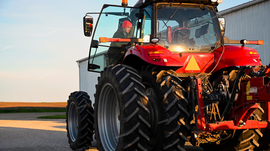 Farmer Climbing into Tractor Cab 25345