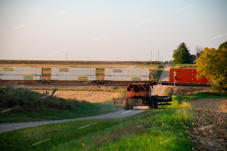 Combine Waiting for Train at Railroad Tracks 25446