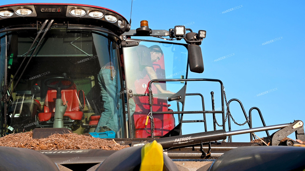 Farmer Climbing Out of Combine Cab 25523