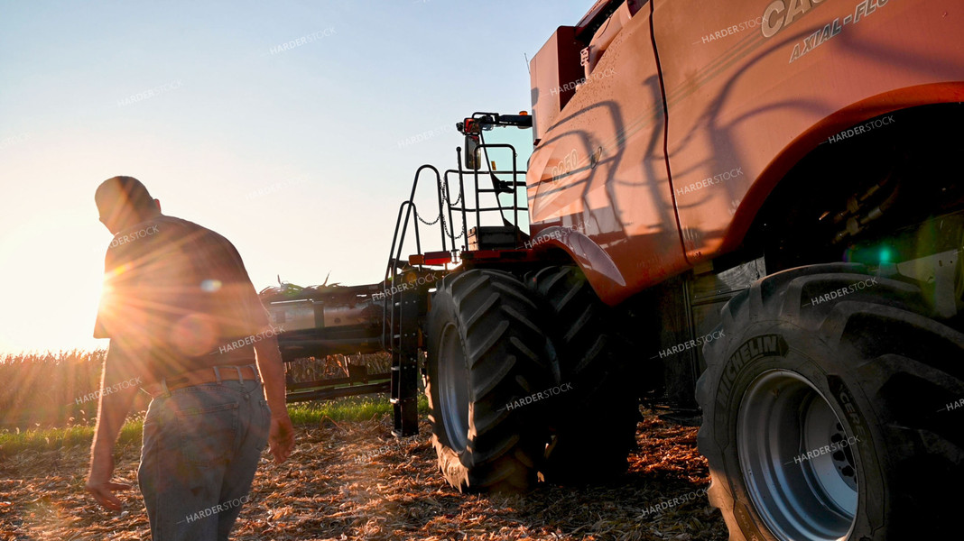 Farmer Walking Alongside Combine 25527