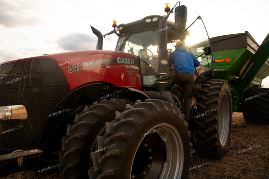 Farmer Climbing into Tractor Cab 25682