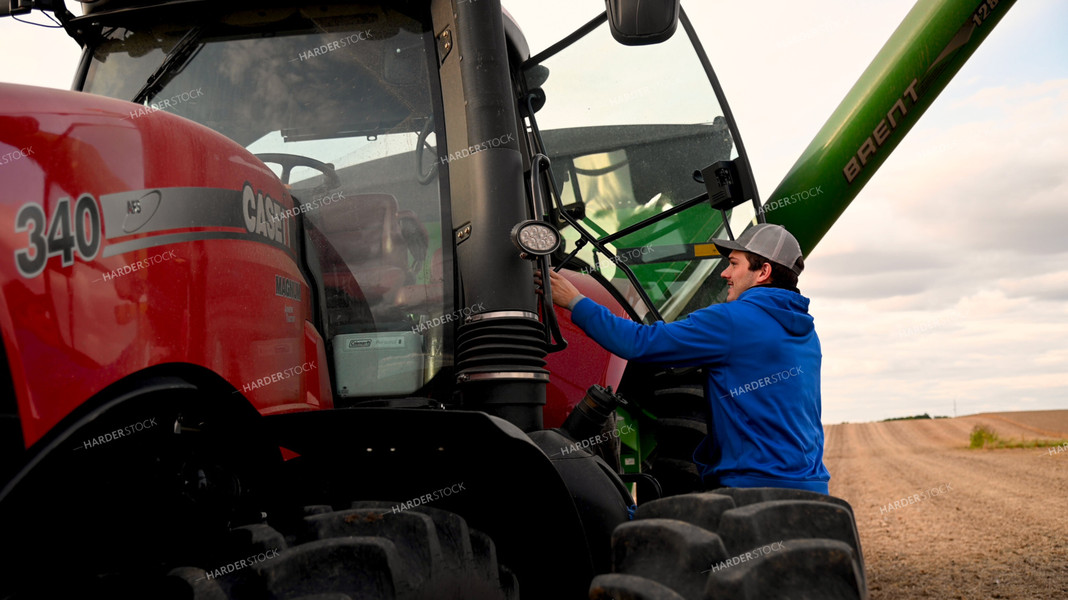 Farmer Climbing into Tractor Cab 25719