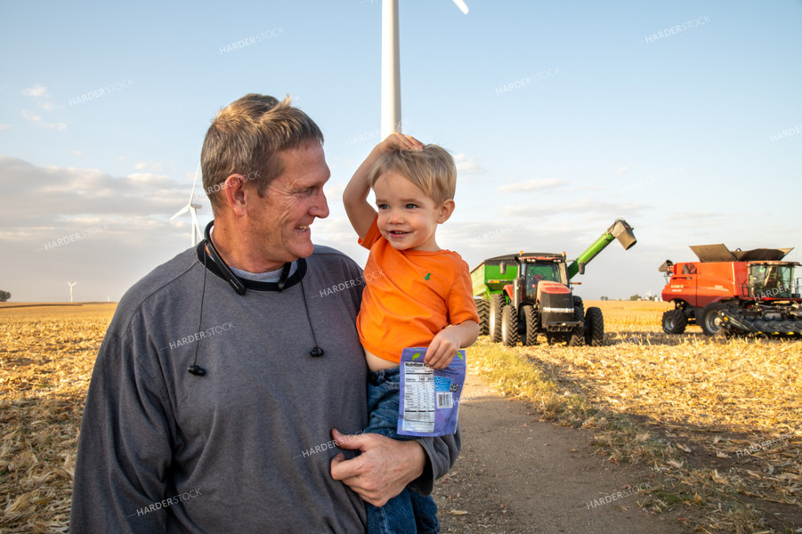 Grandson and Grandfather Farmer in Field 25819