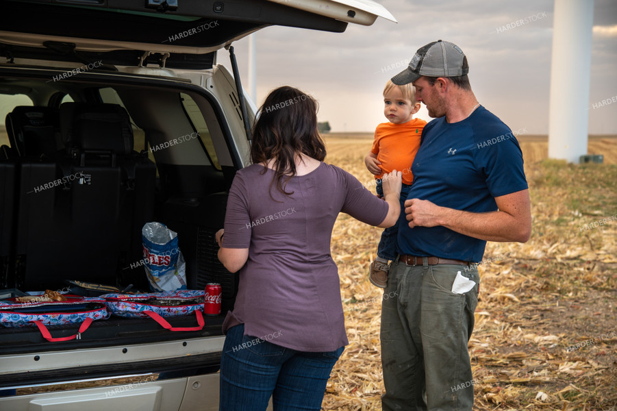 Family Enjoying Harvest Meal in the Field 25823