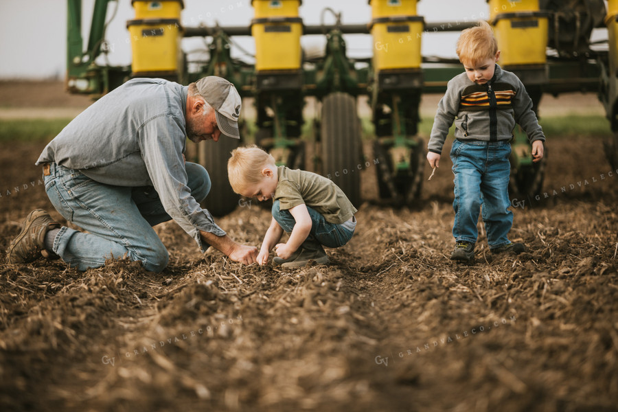 Farmer Checking Seed Depth with Farm Kids 5487