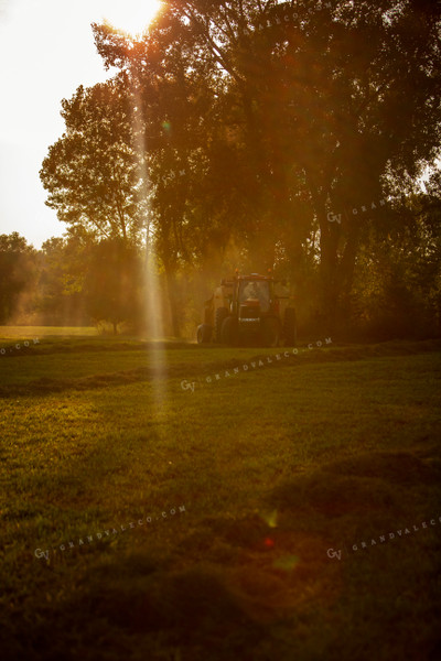 Tractor and Baler with Sun Coming through the Trees 5503