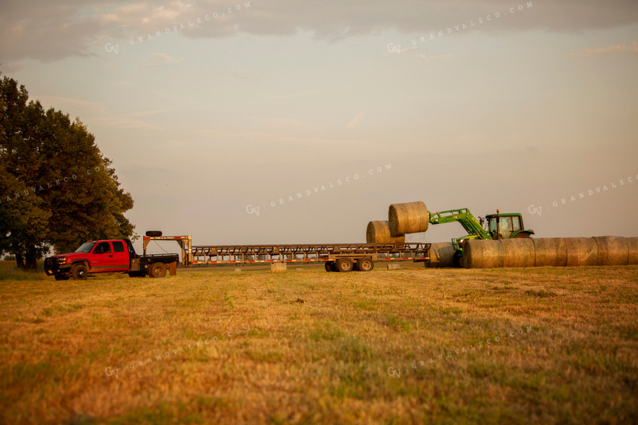 Tractor Loading Hay Bales onto Trailer 5523