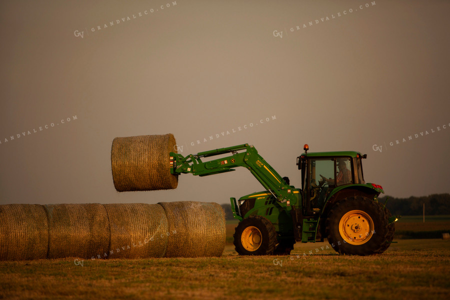 Tractor Lifting Round Hay Bale Overcast Sky 5525