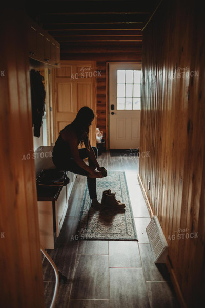 Farmer Putting on Boots 5593