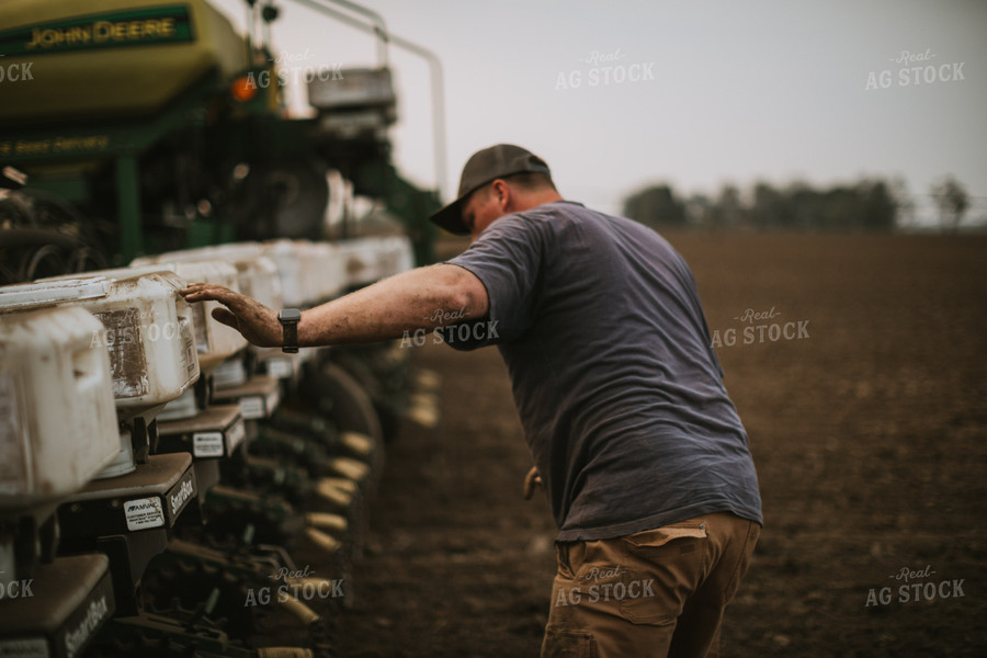 Farmer Adjusting Planter 5689