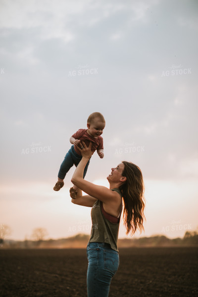 Farm Mom with Farm Kid in Field During Planting 5703