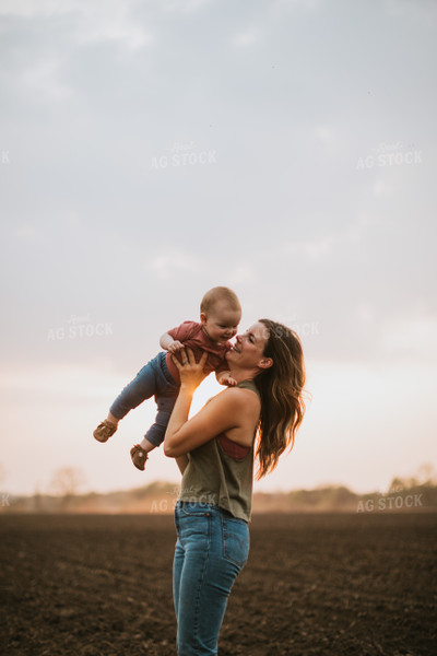 Farm Mom with Farm Kid in Field During Planting 5704