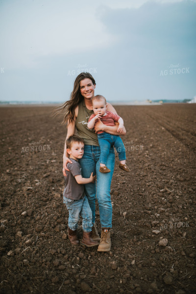 Farm Mom with Farm Kid in Field During Planting 5734