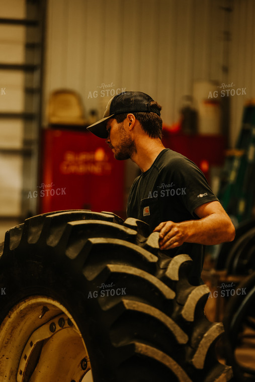 Farmer with Tire in Shed 52440