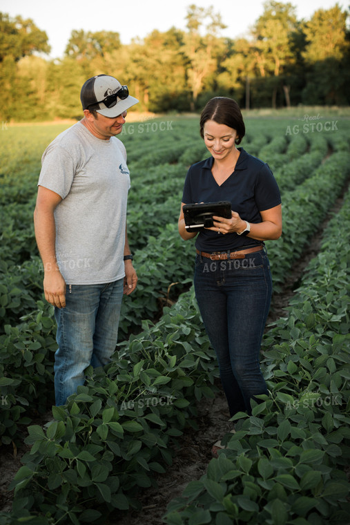 Agronomist and Farmer in Soybean Field Looking at Tablet 6103