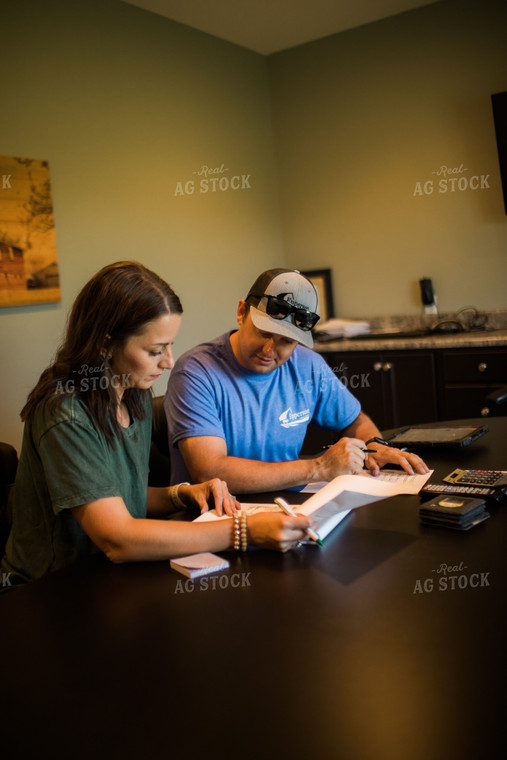 Husband and Wife Farmers Going Over Paperwork 6178