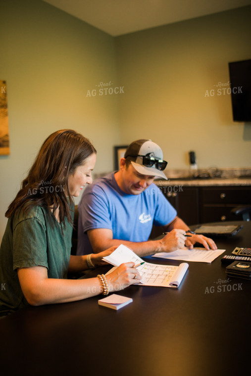 Husband and Wife Farmers Going Over Paperwork 6180