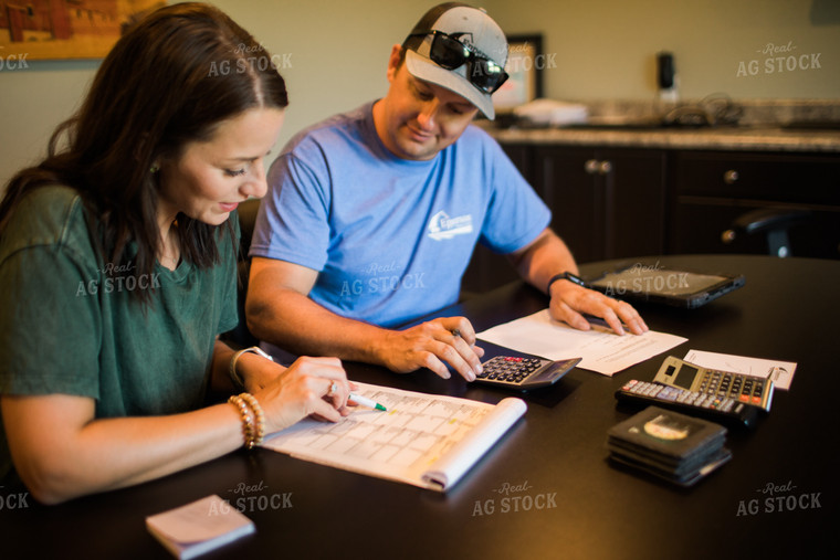 Husband and Wife Farmers Going Over Paperwork 6184