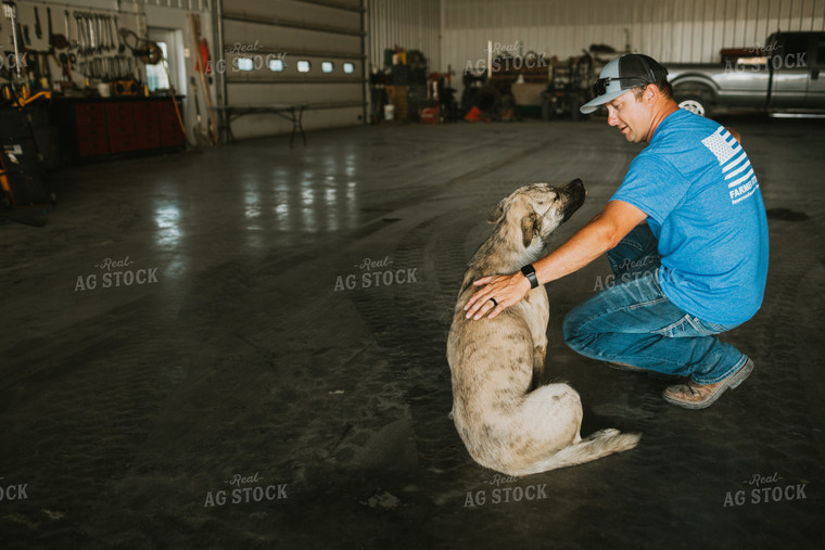 Farmer Petting Dog in Farm Shop 6200