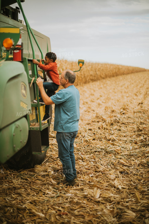 Farmer and Farm Kid Getting into Combine 6661