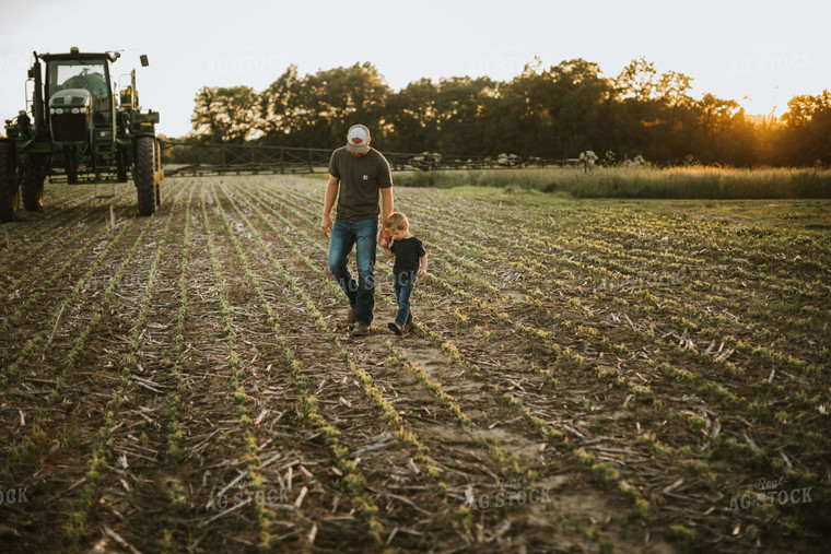 Farmer and Son Walking Through Field 6897