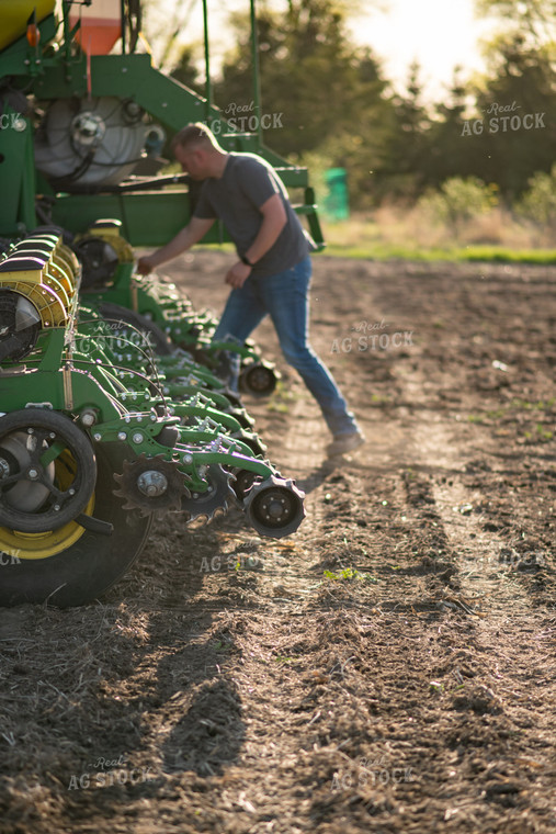 Farmer Fixing Planter 76376