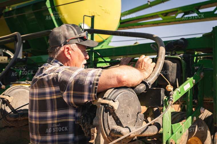 Farmer Working on Planter 128021