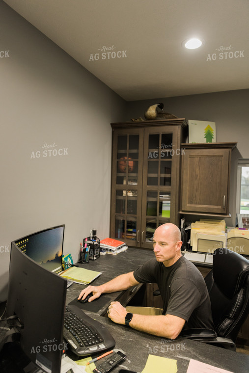 Farmer Works on Computer in Office 7494