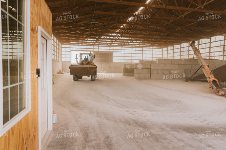 Tractor Loads Dry Feed in Storage Shed 7520