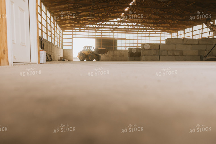 Tractor Loads Dry Feed in Storage Shed 7526