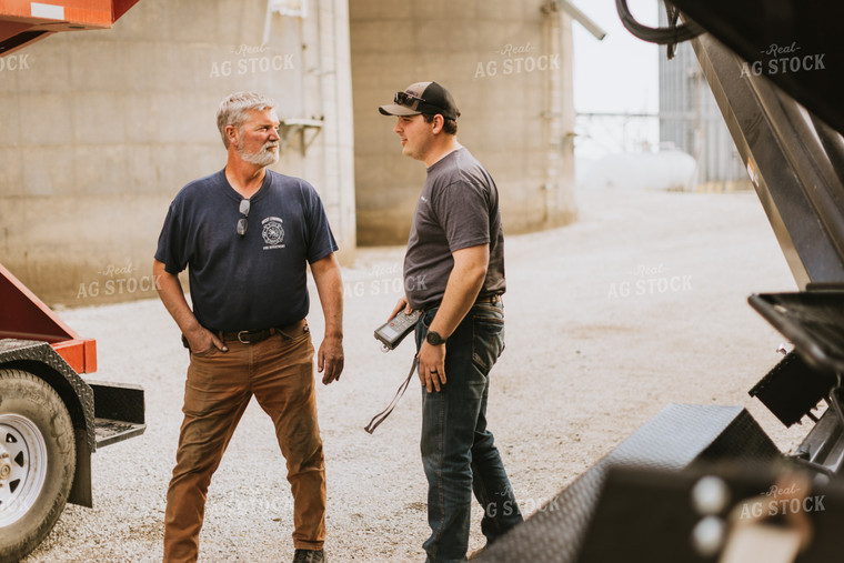 Farmers Talk in Front of Grain Bins 7598