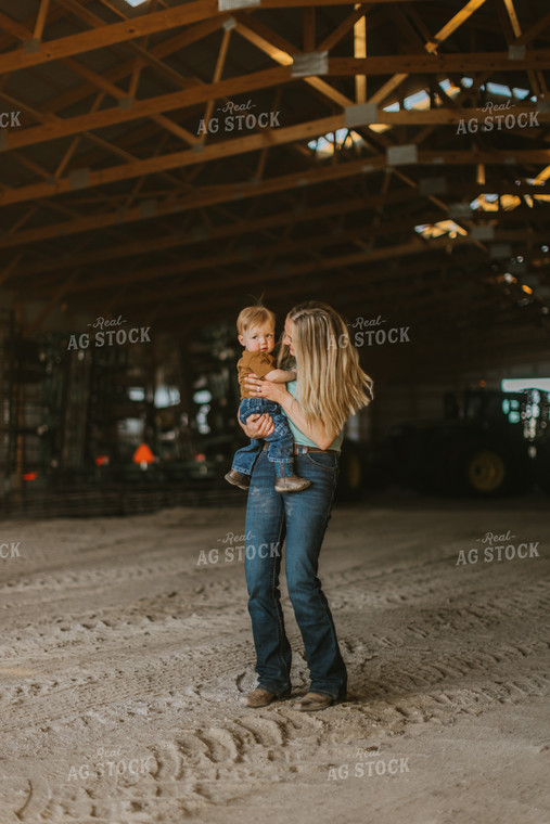 Farm Wife and Child Stand in Shed 7641