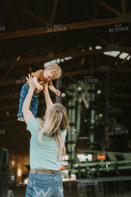 Farm Wife Throws Child in the Air  7642