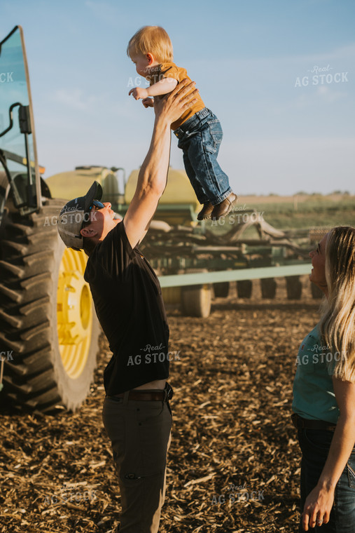 Young Farmer Throws Child in the Air  7665