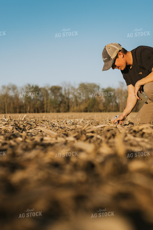 Farmer Checks Seed Depth After Planting 7681