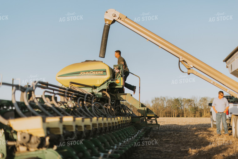 Farmers Fill Planter with Seed Tender in Field 7696