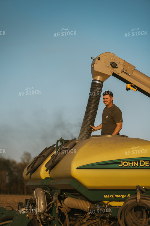 Farmer Fills Planter with Seed Tender in Field 7701