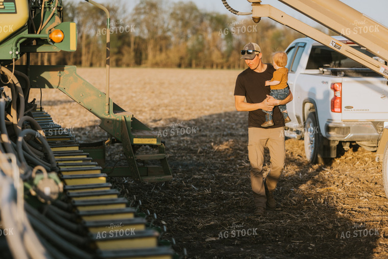 Young Farmer with Child Walks Along Planter 7702