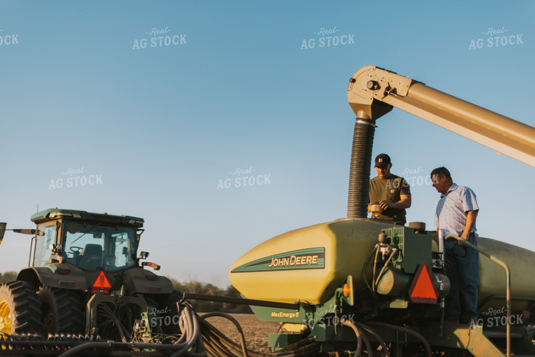 Farmers Fill Planter with Seed Tender in Field 7709