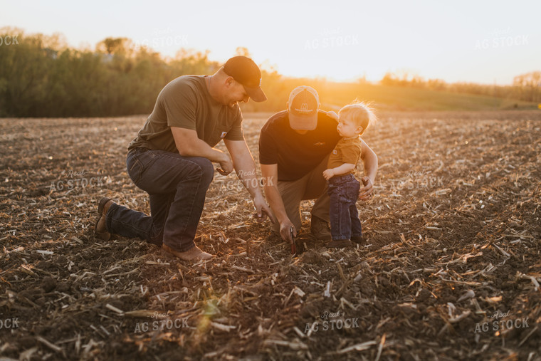 Young Farmers with Child Check Seed Depth After Planting 7713