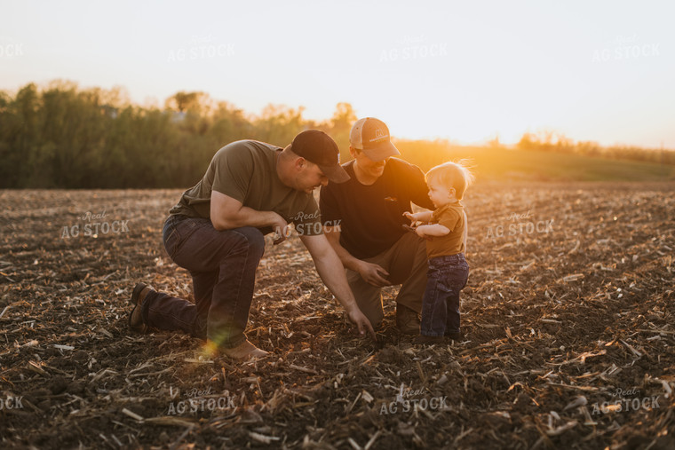 Young Farmers with Child Check Seed Depth After Planting 7714