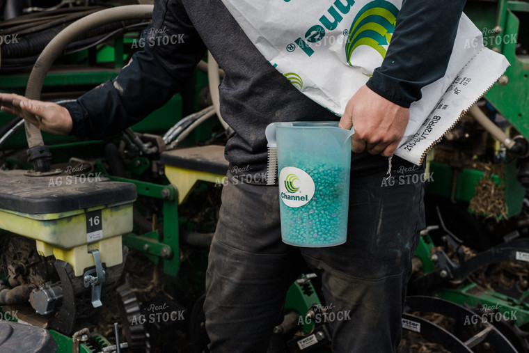 Farmers Pours Seed into Planter 133008