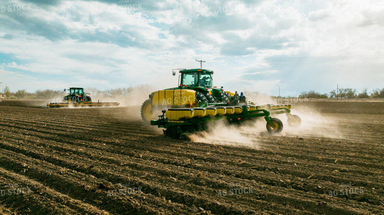 Tractor Rolls Field Ahead of Tractor Planting 56620